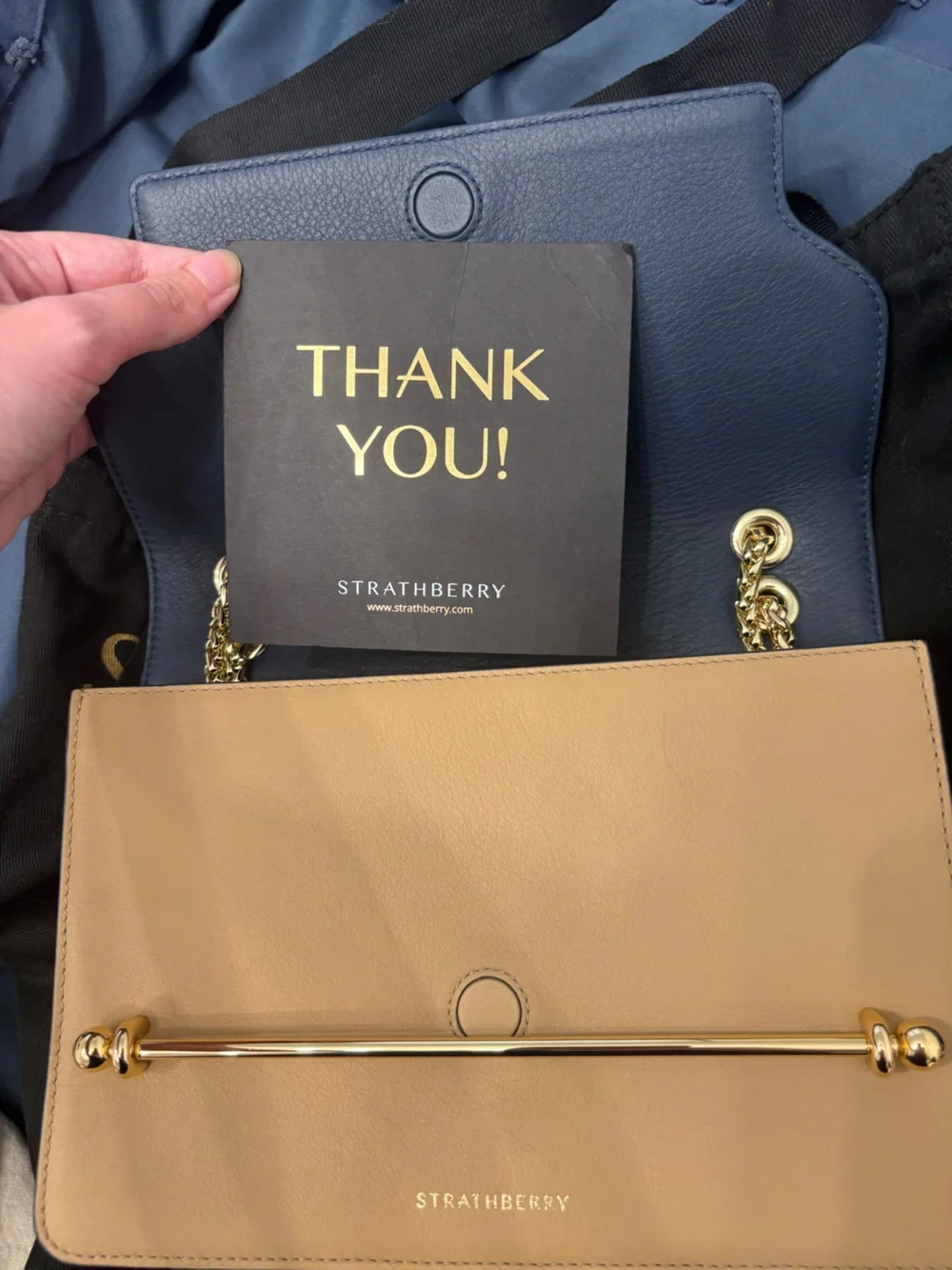 Strathberry blue, cream, and tan crossbody bag with gold hardware